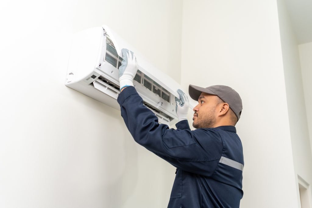 Technician inspecting an indoor air conditioning filter